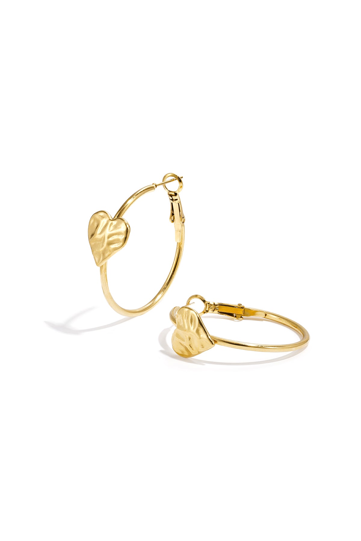 Gold hoop earrings with textured heart detail on white background