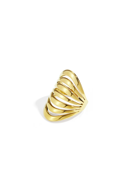 Gold sculptural wave statement ring with a polished openwork design isolated on white background