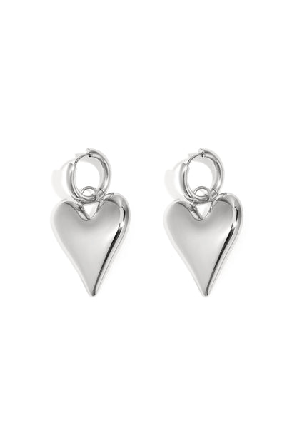 Pair of shiny silver chubby heart-shaped hoop earrings on white background