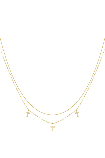 Gold layered necklace featuring two delicate chains with three small cross pendants on a white background
