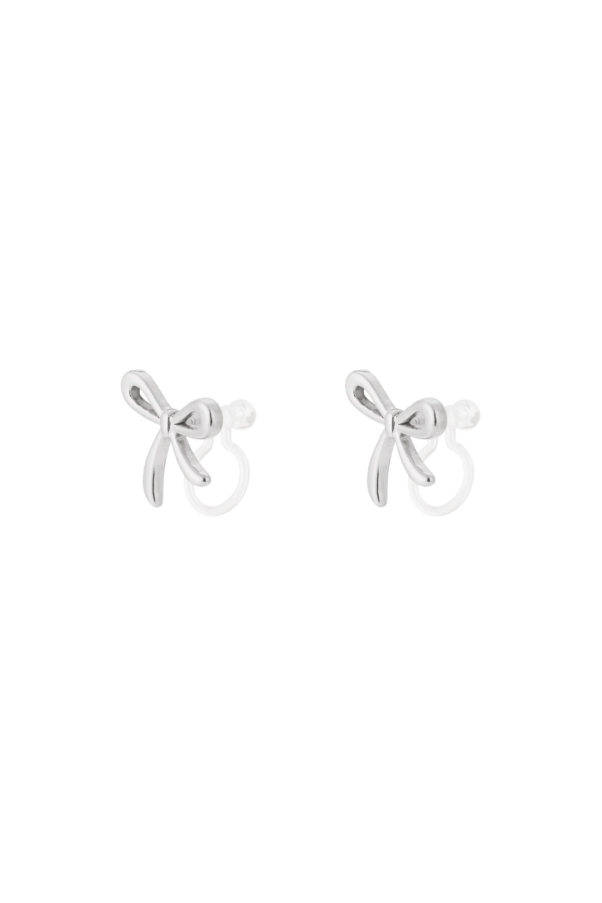 Pair of silver bow-shaped clip-on earrings with smooth polished finish on white background