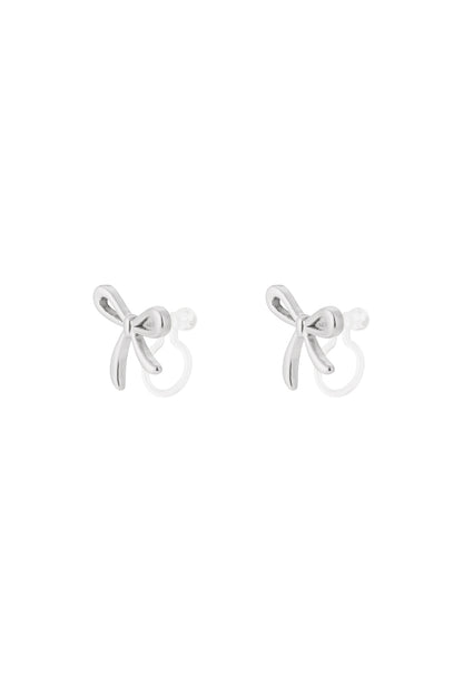 Pair of silver bow-shaped clip-on earrings with smooth polished finish on white background