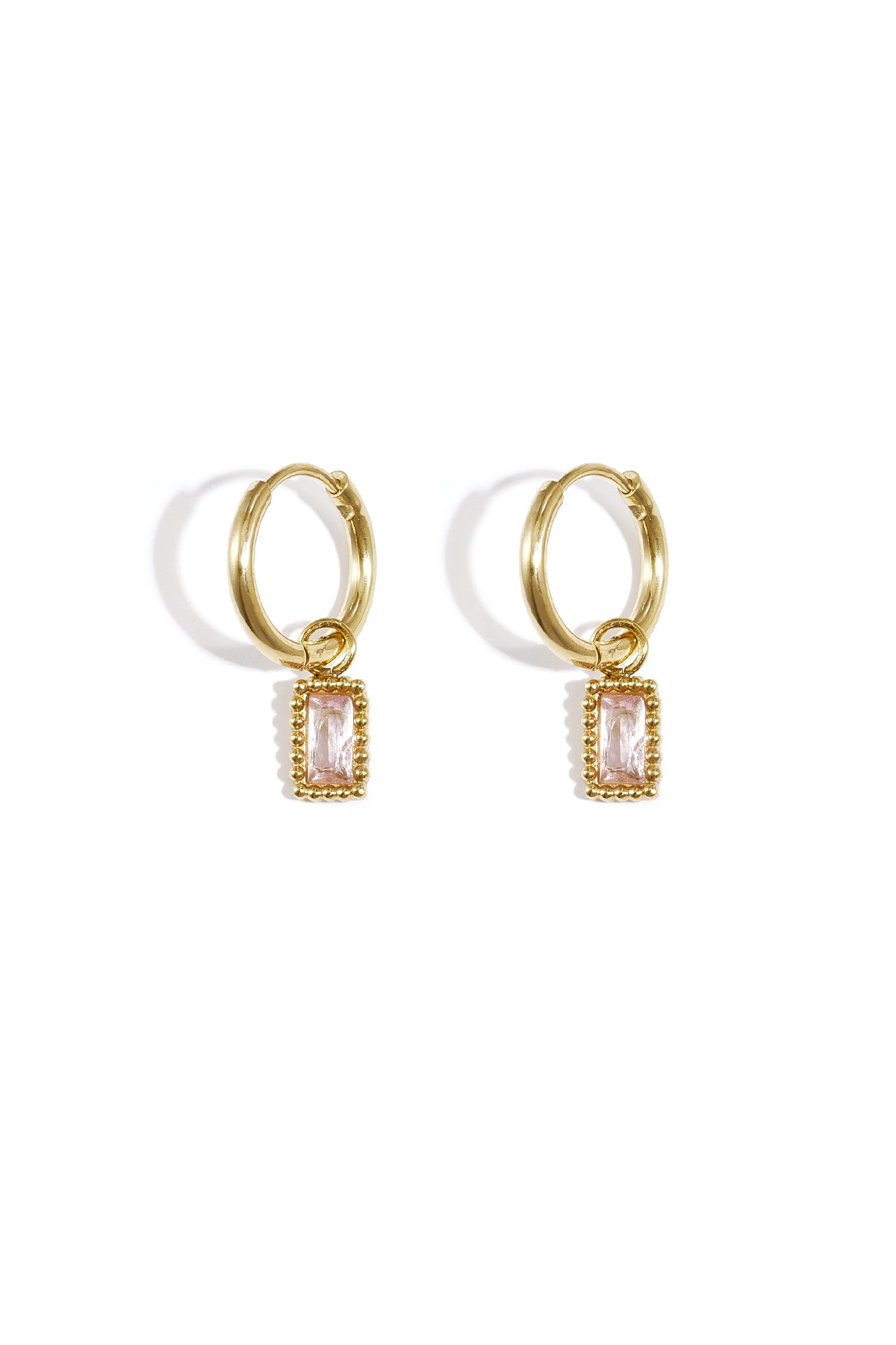 Pair of gold hoop earrings with pink rectangular gemstone charms on a white background