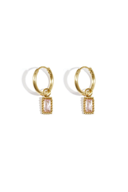 Pair of gold hoop earrings with pink rectangular gemstone charms on a white background