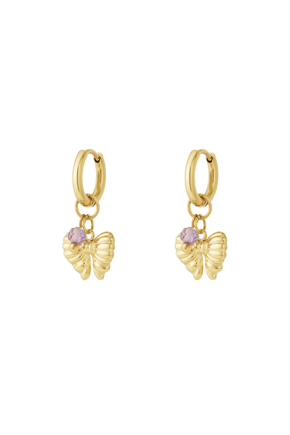 Pair of gold hoop earrings with butterfly charms and light purple beads on white background