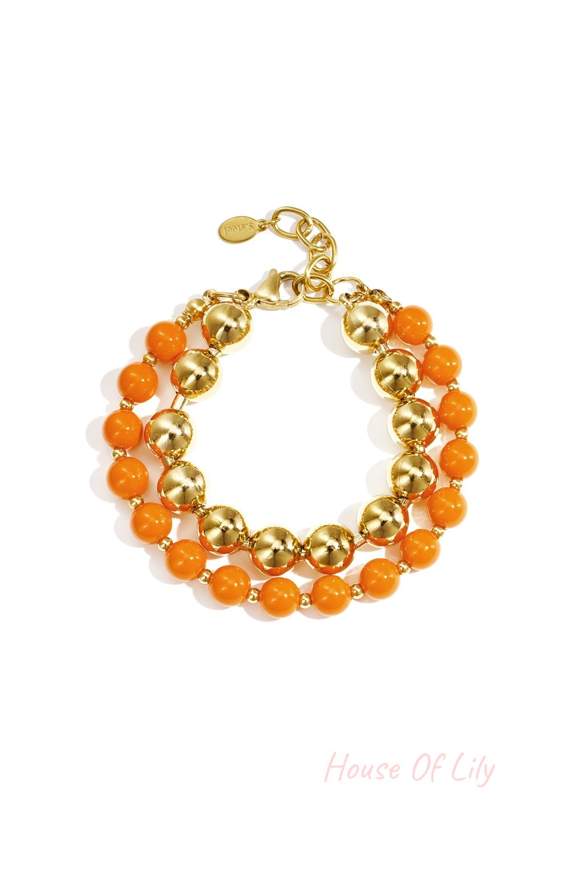 Double layered bracelet with orange acrylic and gold-tone beads on white background