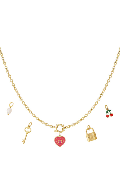 Gold-plated charm necklace laid flat showing five pendants: red heart, golden key, pearl, golden padlock, and red cherries