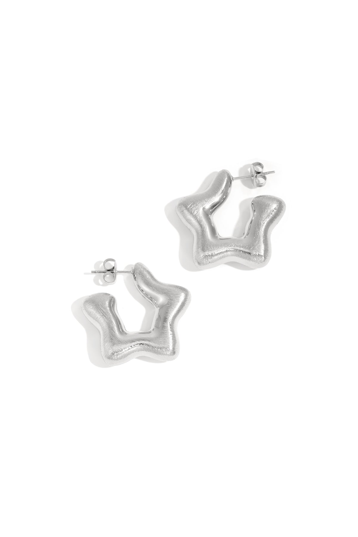 Pair of silver modern sculptural hoop earrings with a smooth, wavy abstract shape displayed on white background