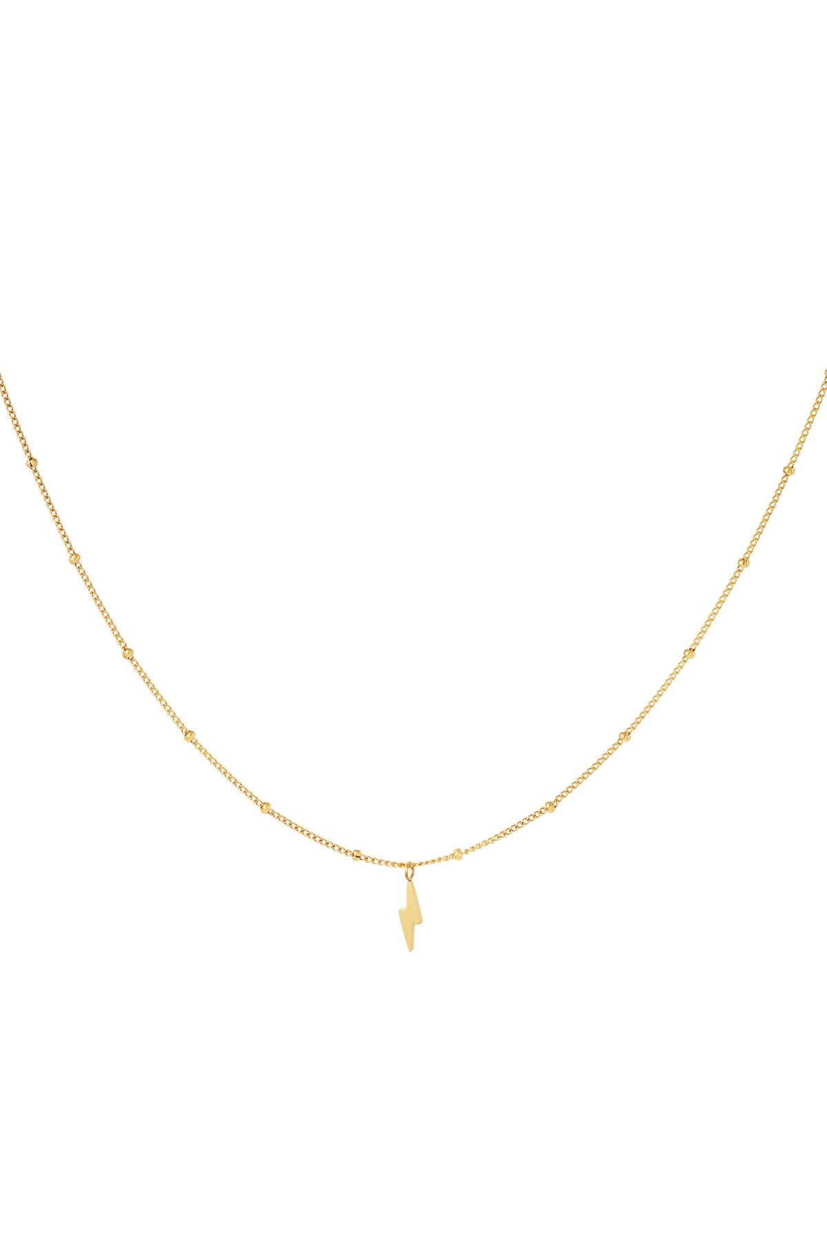 Close-up of delicate gold tone stainless steel necklace with tiny beaded chain and small lightning bolt pendant
