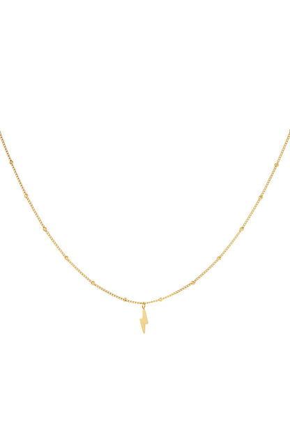 Close-up of delicate gold tone stainless steel necklace with tiny beaded chain and small lightning bolt pendant