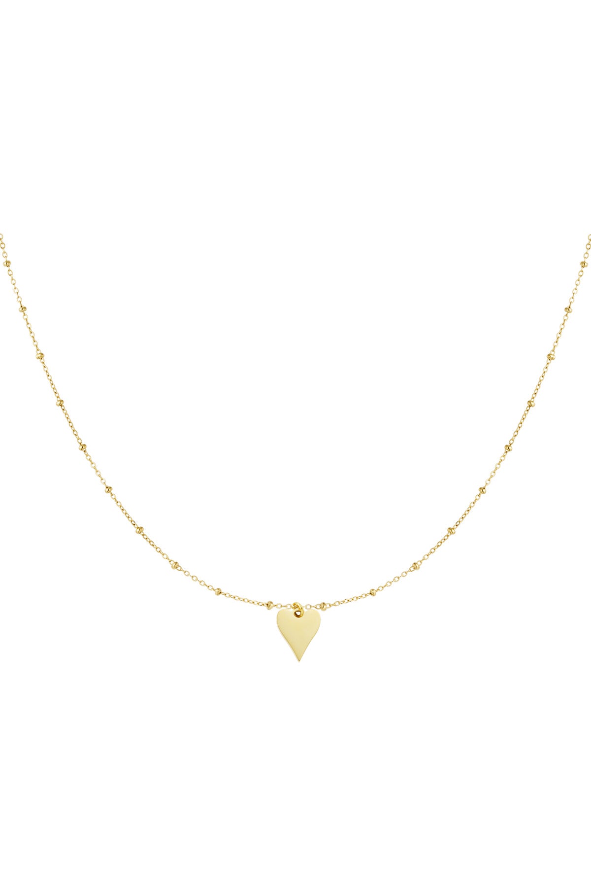 Close-up of delicate gold chain necklace with tiny beads and a small polished heart pendant.
