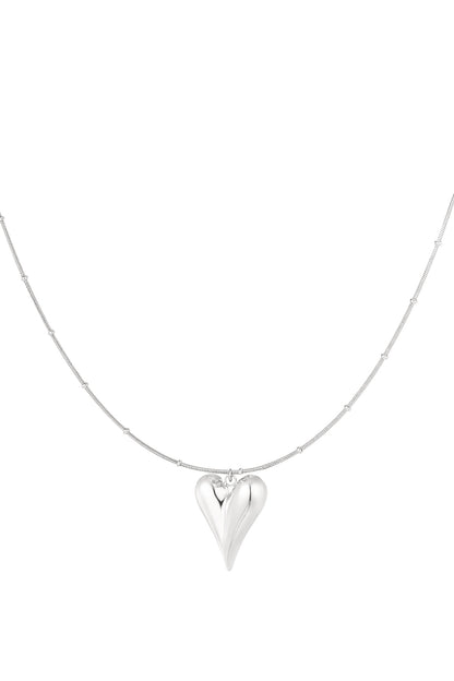 Silver chunky heart pendant necklace with bead-accented chain on white background