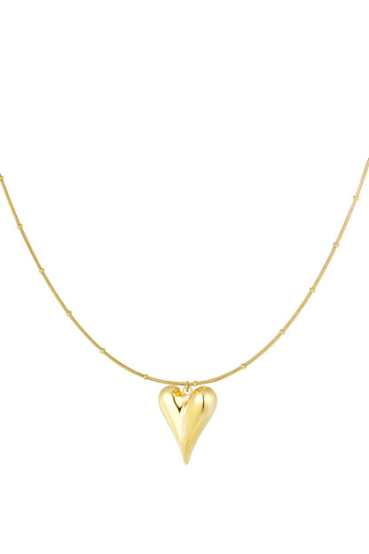 Gold chunky heart pendant necklace with bead-accented chain on white background