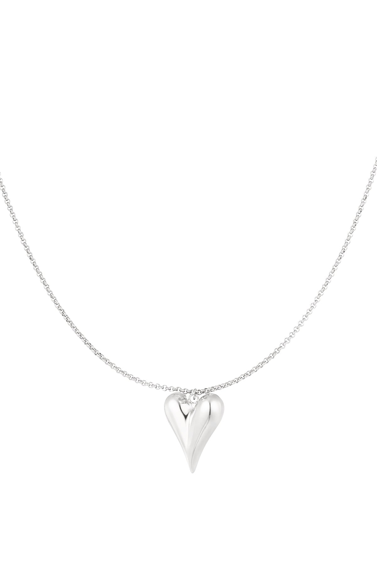 Silver-tone minimalist puffy heart pendant necklace on a delicate chain isolated on white background