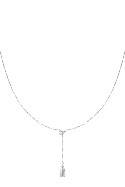 Minimalist silver drop charm necklace with fine chain against white background