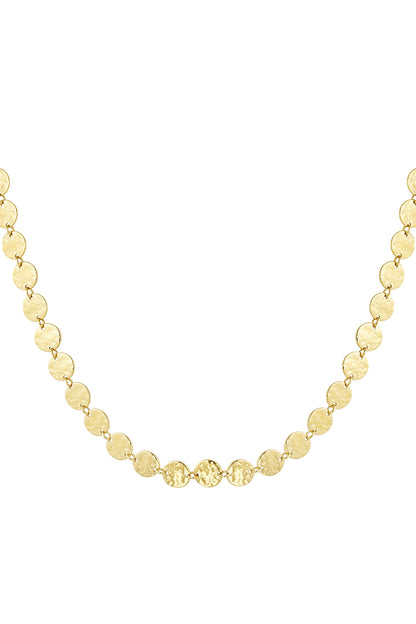 Close-up of hammered gold disc chain necklace with textured round discs linked together