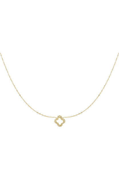 Close-up of delicate gold clover pendant necklace adorned with small rhinestones on fine chain