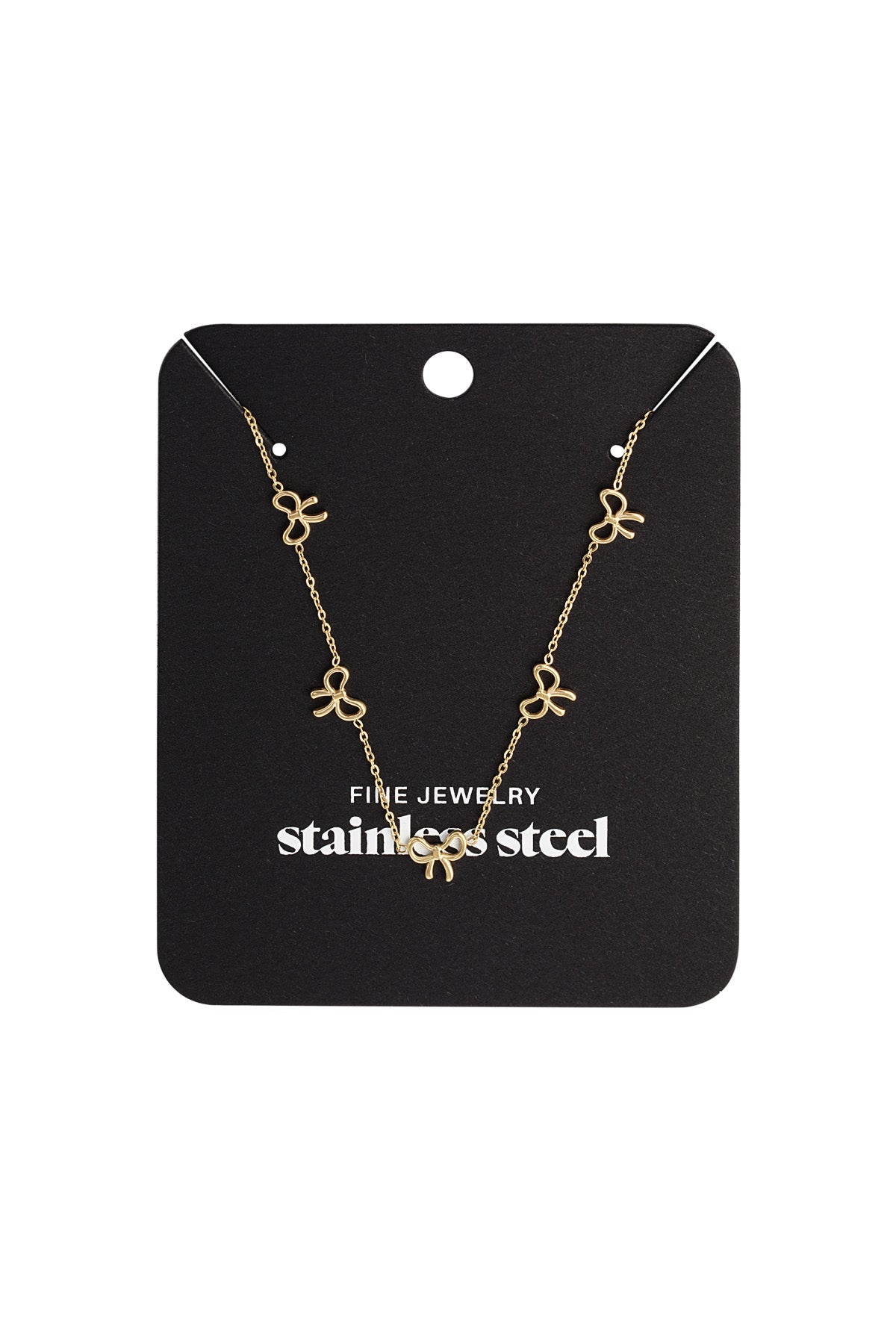 Gold bow charm necklace displayed on a black jewelry card labeled stainless steel fine jewelry