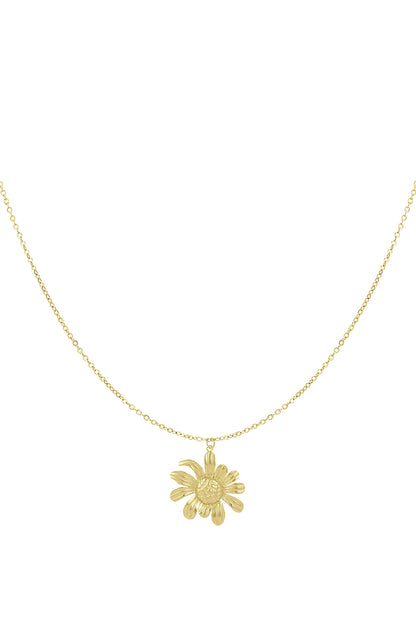 Close-up view of a golden daisy pendant hanging from a delicate chain against a white background