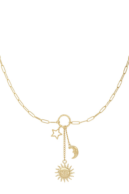 Gold-tone celestial charm necklace featuring sun, moon and star pendants on delicate paperclip chain against white background