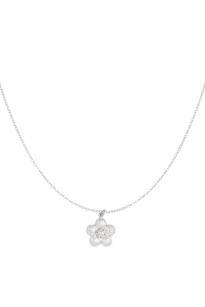 Silver flower pendant necklace with delicate chain on white background