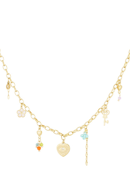 Close-up of a golden charm link necklace with various small pendants including flower, heart, key and colourful beads on a white background