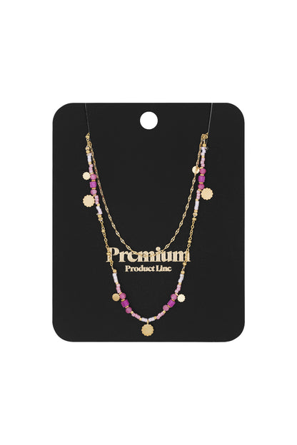 Gold-tone double layered necklace with pink and lilac beads displayed on black jewelry card labeled Premium Product Line