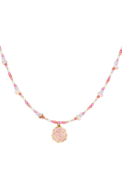 Close-up of pink beaded necklace featuring a gold-tone rose pendant on a white background