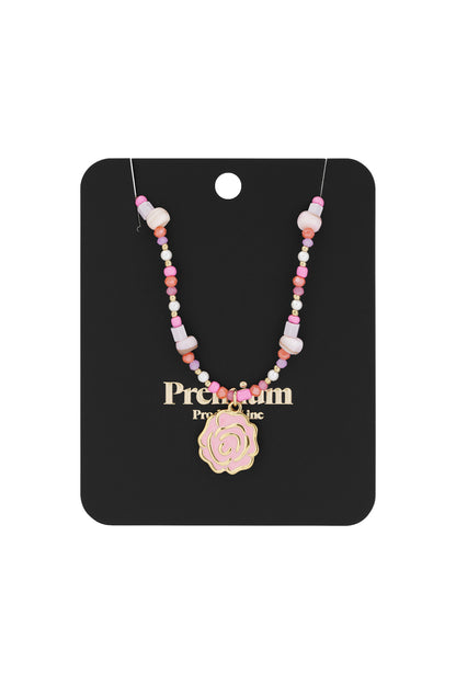 Pink beaded rose necklace displayed on a black jewelry card with gold text