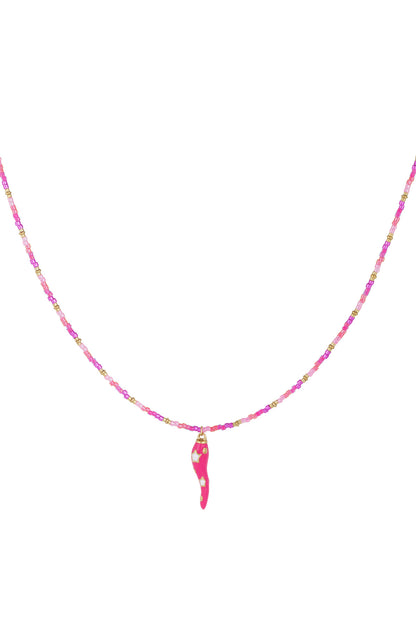 Close-up of pink and gold beaded necklace with bright pink chili pepper pendant decorated with white stars on white background