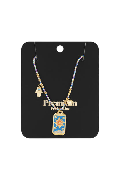 Packaged braided necklace with gold sun, heart, and Hamsa hand charms on black product card