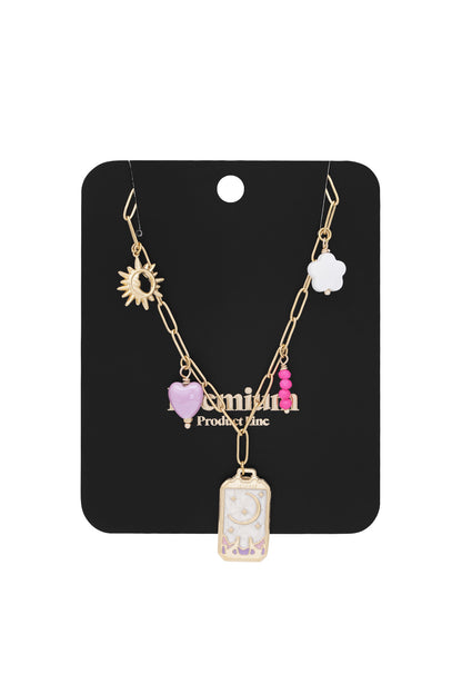 Gold-tone charm necklace displayed on black packaging card showing all charms clearly