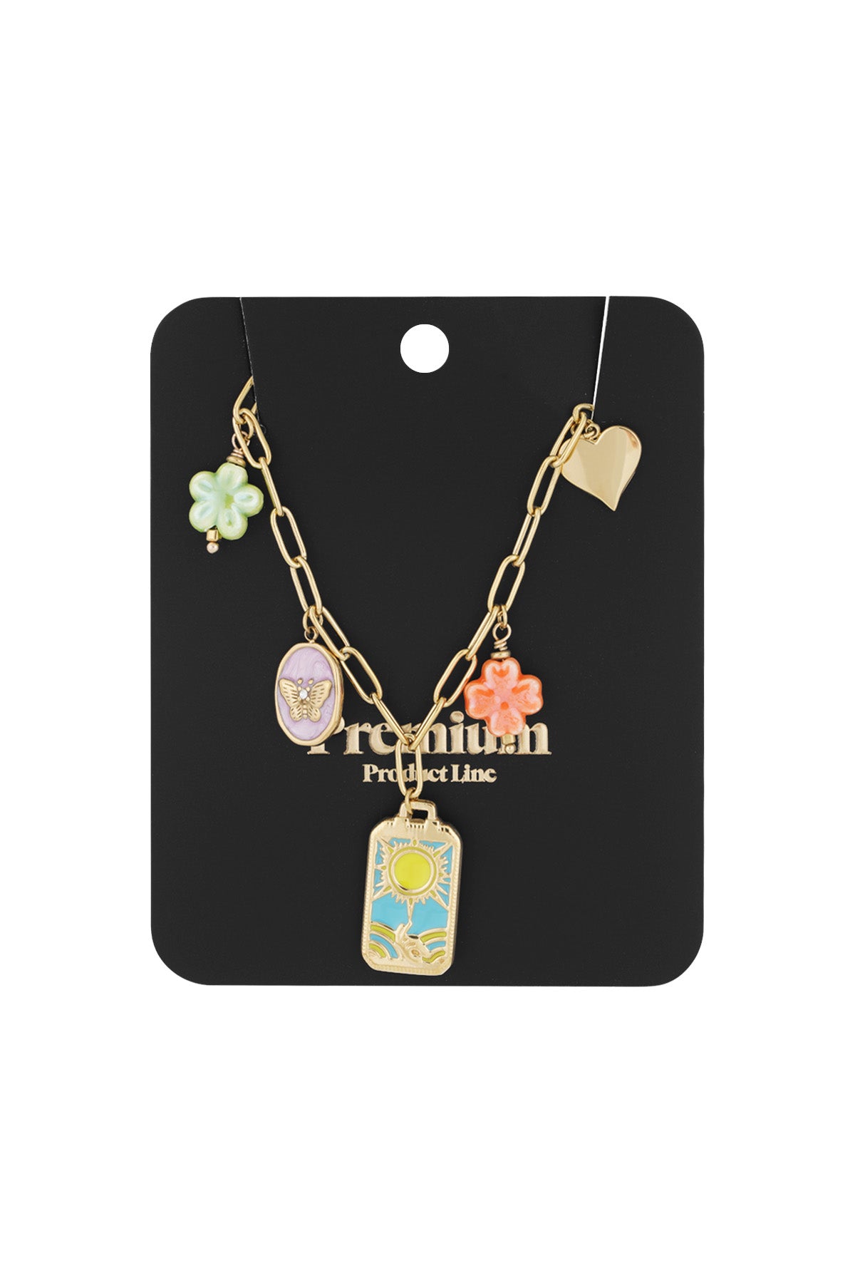 Packaged gold-tone charm link necklace displayed on black card featuring butterfly cameo, sun charm, flower charms, and turquoise heart charm