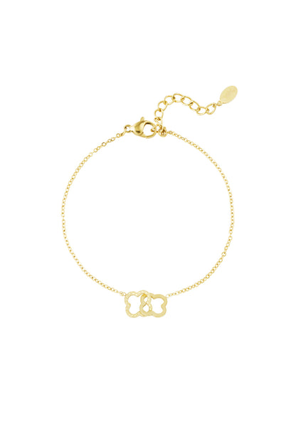 Gold stainless steel bracelet with two linked clover-shaped charms on a fine chain and adjustable clasp