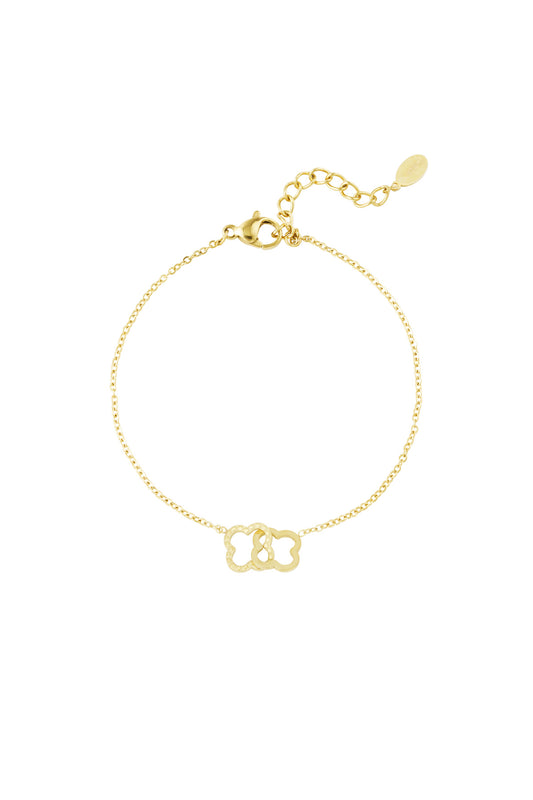 Gold stainless steel bracelet with two linked clover-shaped charms on a fine chain and adjustable clasp