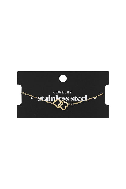 Gold linked clover bracelet displayed on a black card labelled 'stainless steel jewelry'