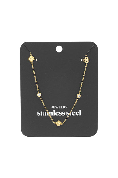 Gold-tone clover chain necklace attached to a black display card labeled stainless steel jewelry