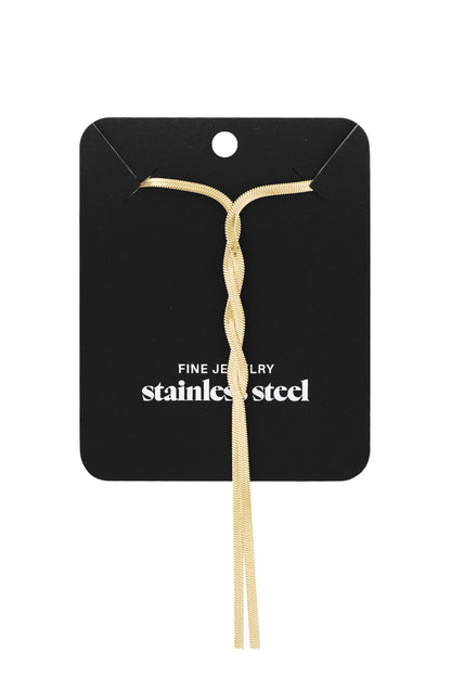 Gold twist necklace displayed on black card labeled 'Fine Jewelry Stainless Steel'