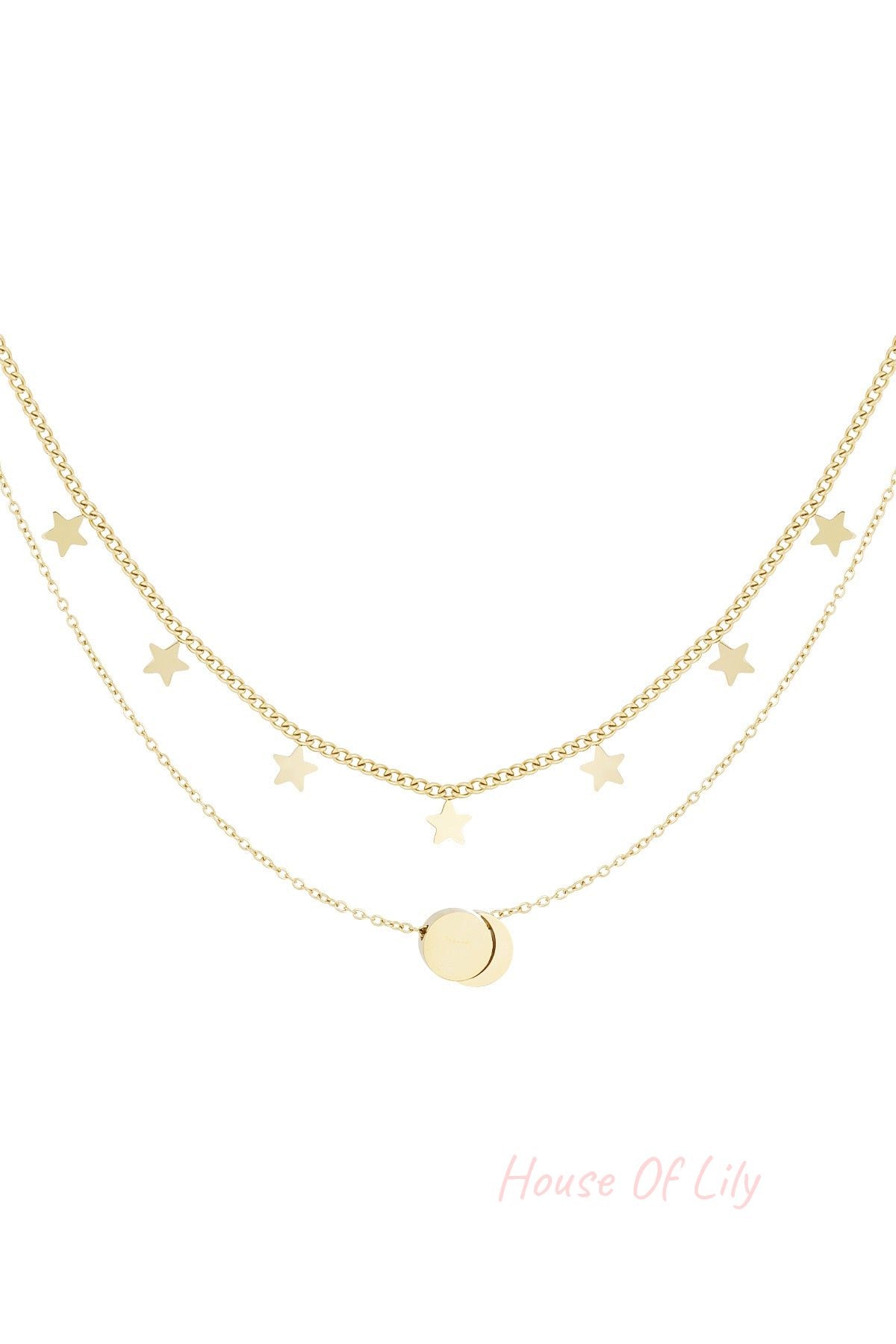 Gold layered necklace with star charms and round pendant on white background