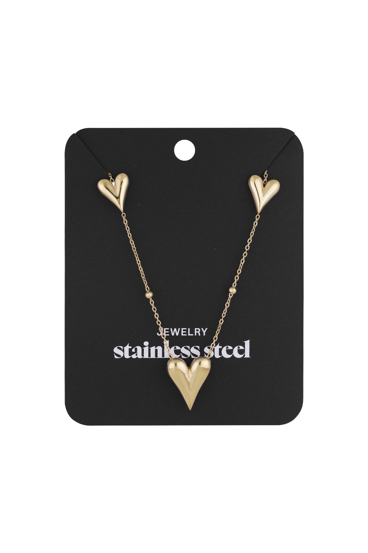 Gold heart charm necklace displayed on black packaging card, labeled stainless steel jewelry