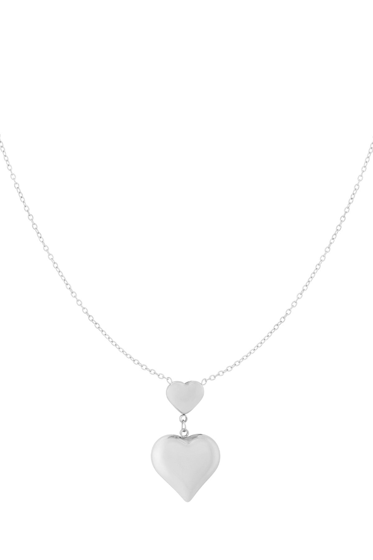 Silver double heart pendant necklace featuring the same design with two connected hearts on a fine chain, white background