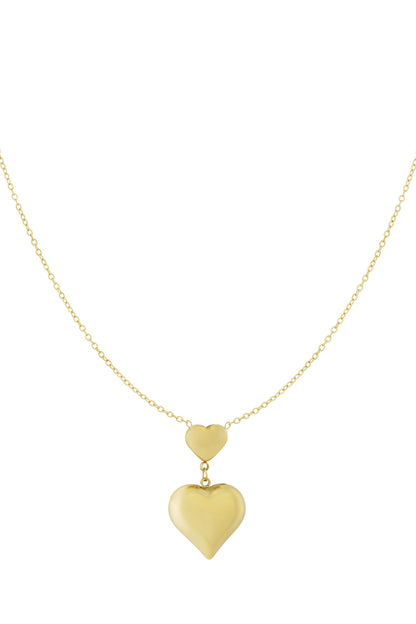 Gold double heart pendant necklace with a small heart connected above a larger heart on a fine chain, displayed on white background