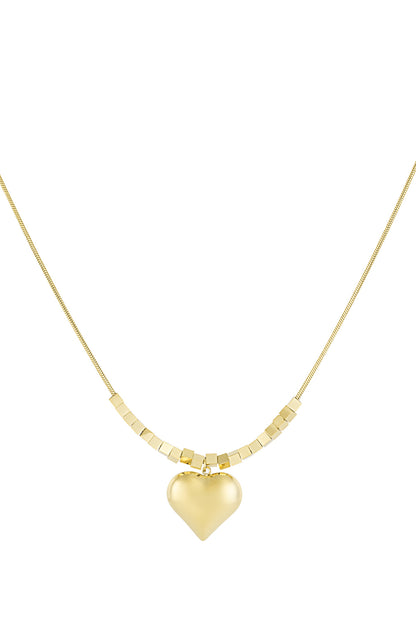 Gold chunky heart pendant necklace with cube bead chain on white background