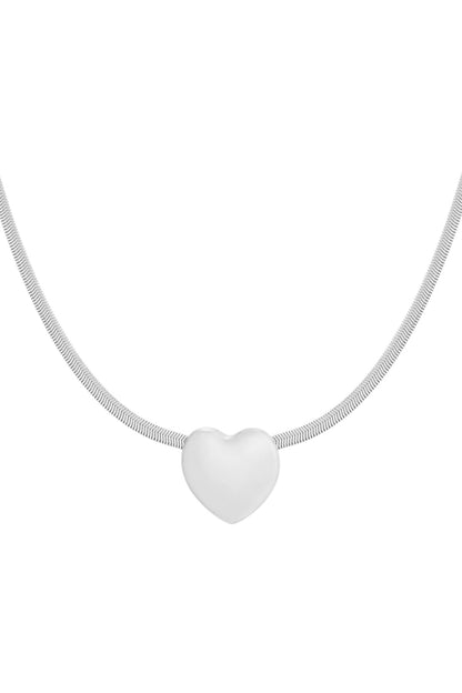 Silver-tone heart pendant necklace on a white background highlighting sleek, smooth design and fine snake chain.