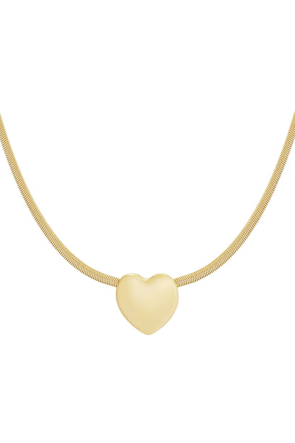 Close-up of a gold-tone heart pendant necklace with a smooth finish on a fine snake chain.