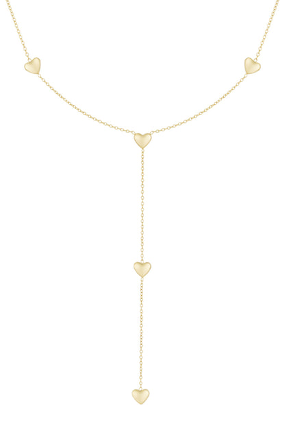 Gold tone delicate heart drop necklace with multiple heart charms and lariat chain design on a white background