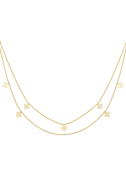 Double-layer gold necklace with small four-leaf clover charms evenly spaced on delicate chains