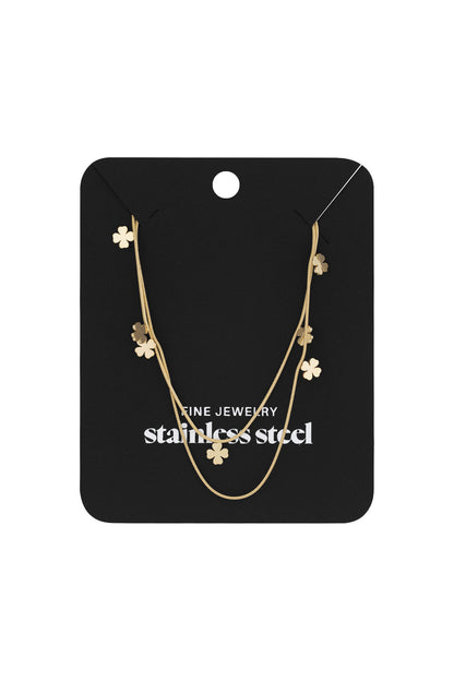 Gold-tone double-layer clover necklace displayed on black jewelry card with fine stainless steel label