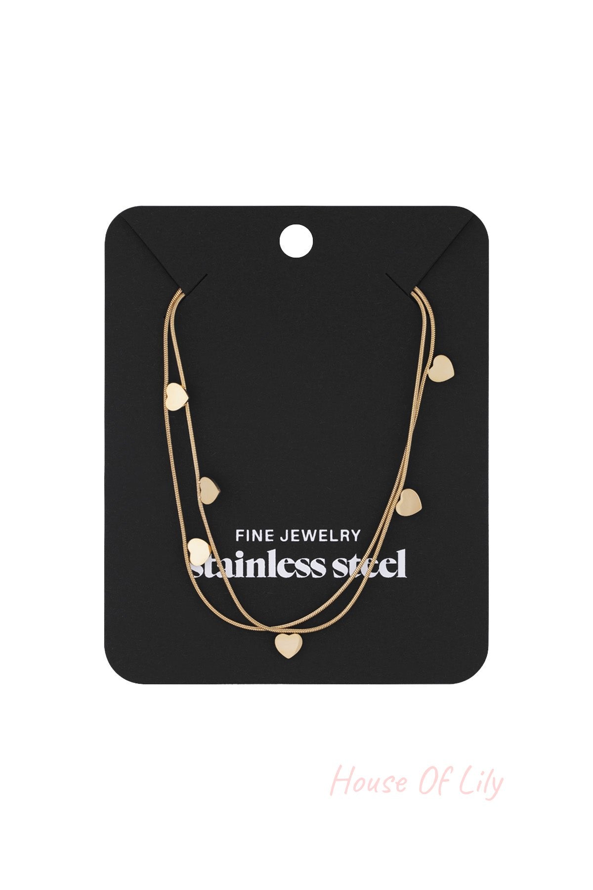 Gold layered heart charm necklace displayed on black jewelry card labeled fine jewelry stainless steel