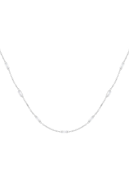 Silver tone delicate chain necklace with rectangular clear crystals spaced evenly along the chain on white background